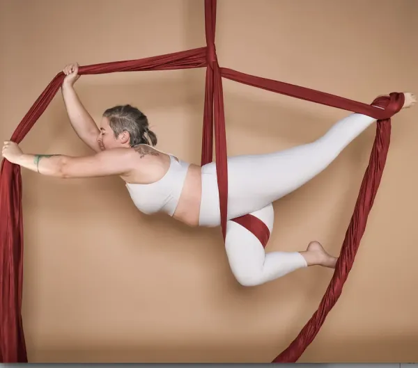 Aerial silks student climbing and wrapping in hanging fabric during a class at Flexibility in Flight in Chester, NY